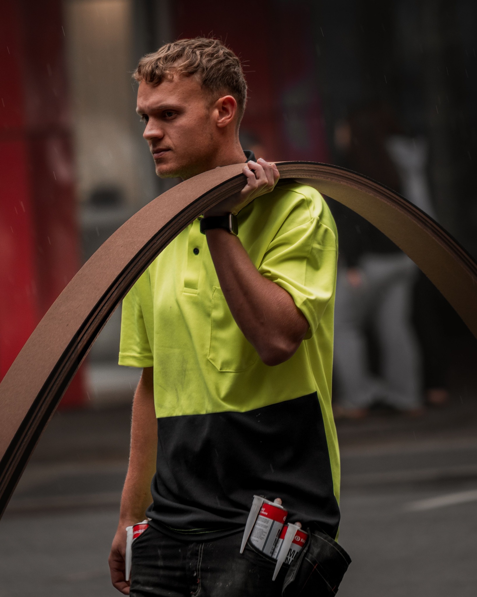 Tradesperson carrying curved material